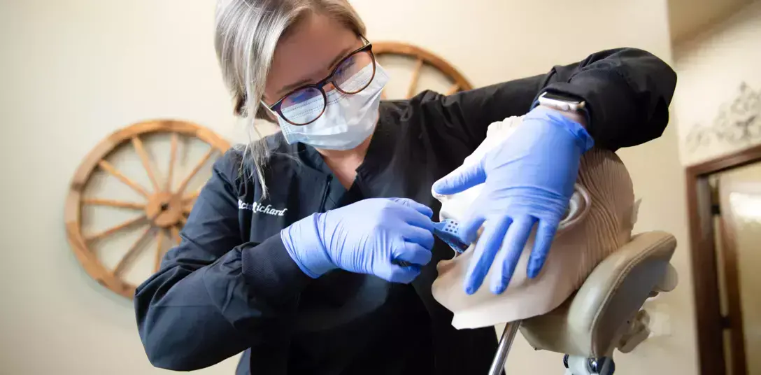 instructor demonstrating a dental examination