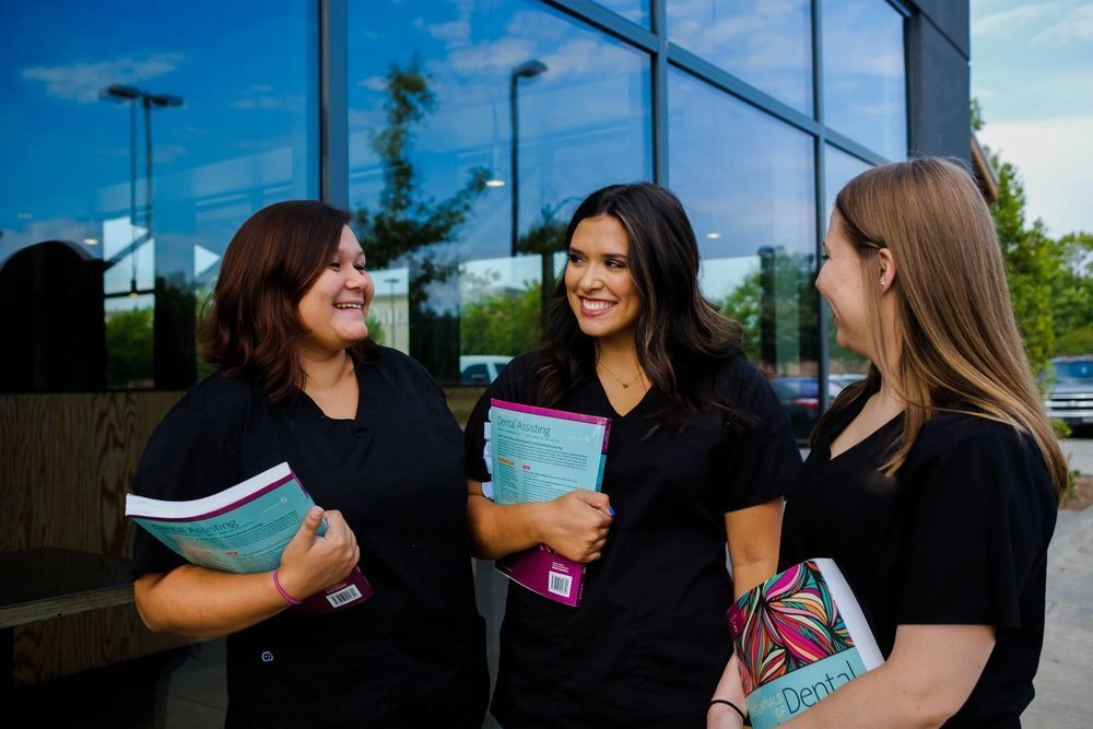 students outside of facility with their workbooks in hand